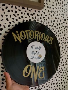 a person holding up a record with writing on it