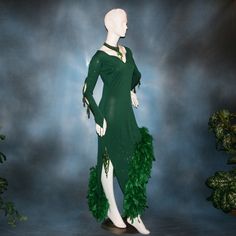 will fit size 5/6-11/12, very stretchy This luxurious Latin-rhythm dress exudes glamour with emerald chandelle feathers, glimmering slinky fabric, and opulent hand beading. Its long-sleeved design has several peek-a-boos, ensuring you turn heads on the dance floor. Plus, a matching choker with dazzling gold aurum Swarovski rhinestones and hand beading finishes the look. Feel confident and stylish in this stunning dress - ready for a sizzling tango or any other Latin-rhythm occasion! (color of dr Green Feathered Evening Dress, Fitted Green Dress With Feather Trim, Rhythm Dress, Dress Feathers, Green Feathers, Deep Emerald Green, Latin Dress, Jade Green, Stunning Dresses