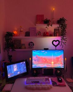 two computer monitors sitting on top of a desk in front of a keyboard and mouse