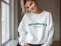 Represent your love for the Philadelphia Eagles with this comfy unisex crewneck; or gift it to the Eagles lovers in your life! This cozy sweatshirt is made of medium-heavy fabric. It runs true to size, so size up for a more loose, oversized fit. The collar is ribbed knit, so it will retain its shape even after washing. Plus, no itchy side seams of these sweaters! ~ 50% cotton, 50% polyester ~ Medium-heavy fabric (8.0 oz/yd² (271.25 g/m ~ Loose fit ~ Sewn-in label ~ Runs true to size Pre-shrunk Long Sleeve Sweatshirt, Pre-shrunk Long Sleeve Sweatshirt For Everyday, Everyday Long Sleeve Sweatshirt, The Eagles, Football Sweatshirt, Cozy Sweatshirts, Philadelphia Eagles, Sew-in Labels, Heavy Fabric