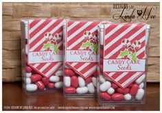 three candy bags with candy canes in them sitting on a table next to each other