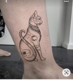 a black and white cat tattoo on the right side of the leg, with space around it