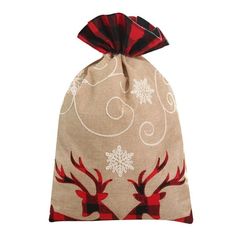 a bag with reindeers and snowflakes printed on it, sitting against a white background