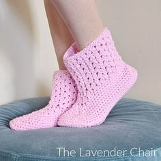 there is a woman's legs with crochet socks on top of a chair