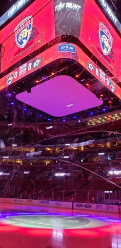 an ice rink with lights and signs on it