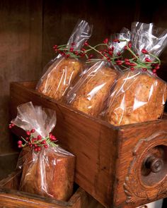 some bread wrapped in plastic sitting on top of a wooden box next to other items