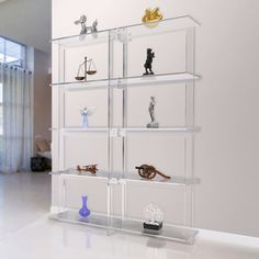 a display case filled with lots of different types of figurines on top of glass shelves