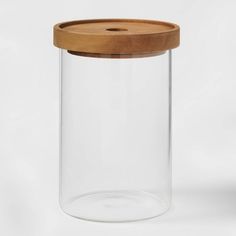 a clear glass jar with a wooden lid