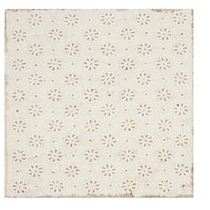 a white rug with small flowers on the top and bottom, against a white background