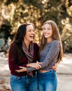 two young women laughing and hugging each other