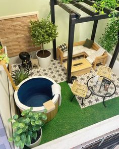 a miniature hot tub in the middle of a small patio area with potted plants