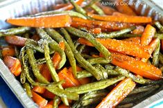 cooked carrots and green beans in a tin container