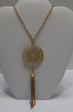 "Vintage gold tone pendant necklace. 32\" chain--pullover chain. 1 3/4\" diameter pendant with 3\" dangling chain fringe. Pendant is smooth on one side & intricate on the other. Could possibly be worn either way. Excellent condition." Vintage Yellow Gold Necklaces With Large Pendant, Vintage Gold-tone Round Pendant Jewelry, Ornate Yellow Gold Pendant Jewelry, Gold Tassel Necklace With Adjustable Chain, Vintage Gold-tone Medallion Necklace, Vintage Gold-tone Necklace With Large Pendant, Gold Metal Dangle Tassel Necklace, Gold Metal Tassel Dangle Necklace, Chain Fringe