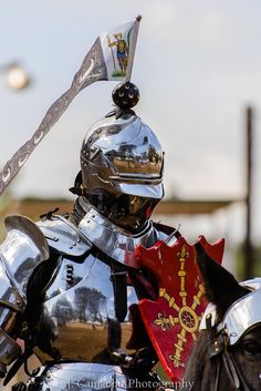 a man in armor riding on the back of a horse