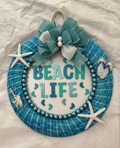 a beach life wreath with starfish, shells and seashells