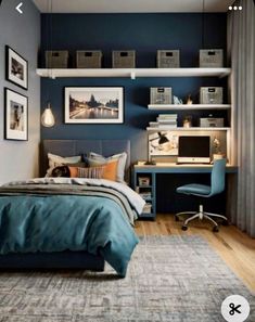 a bedroom with blue walls and pictures on the wall above the bed, along with a computer desk