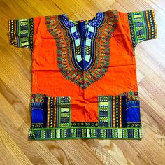 Colorful African Dashiki Top Size Large New Never Worn. Traditional Orange Cotton Tops, Blue Cotton Tops With Colorful Pattern, Blue Cotton Top With Colorful Pattern, Multicolor Batik Print Short Sleeve Top, Multicolor Short Sleeve Tops With Batik Print, Colorful Orange Tops For The Beach, Orange Beach Top With Colorful Pattern, Orange Cotton Festival Top, Vibrant Orange Printed Top