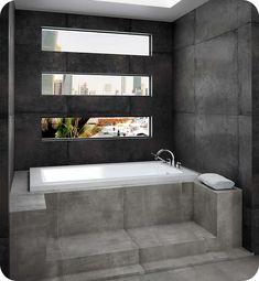 a bathroom with a large bathtub next to a window and tiled floored walls