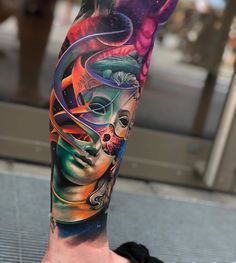 a man's leg with colorful tattoos on it and an image of a woman