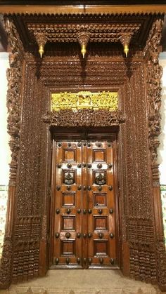 an ornate wooden door with intricate carvings on it