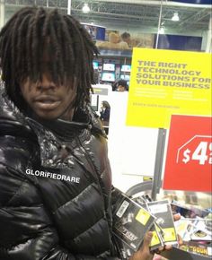 a man with dreadlocks standing in a store