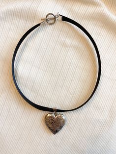 Beautiful silver heart locket necklace with a black ribbon! ☆❤️️ Necklace is 14in long. Pls message us if you'd like to adjust the length! 🎀Thank you for supporting my business!🎀 Ribbon Heart Necklace, Cool Jewelry Necklaces, Black Ribbon Necklace, Black Heart Choker Necklace For Gift, Black Heart Choker Necklace Gift, Gift Black Heart Choker Necklace, Black Choker For Valentine's Day Gift, Valentine's Day Gift Black Choker, Adjustable Black Heart Choker Necklace