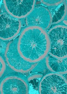 a group of orange slices sitting on top of each other in the middle of blue water