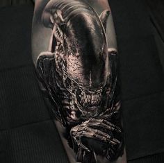 a man with a tattoo on his arm that has an image of a predator in it