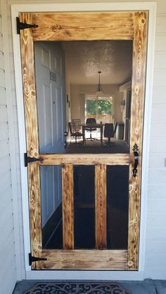 the front door is made out of wood and has a glass paneled in to it