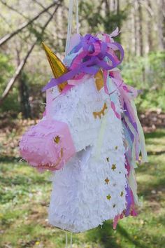 a unicorn pinata hanging from a string