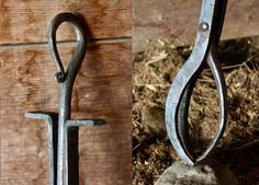 an old pair of scissors hanging from a hook on a wooden wall next to a pile of hay