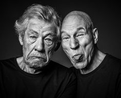 two older men are posing for a black and white photo with their faces close together