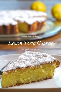 lemon torta caprese with powdered sugar on top and two plates in the background