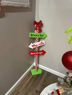 a christmas tree with signs on it in front of a wall