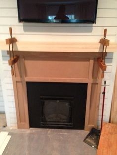 a flat screen tv mounted above a fireplace