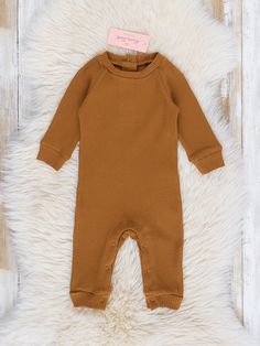 Ready for some fashion-forward fun? Our Ribbed Knit Crew Neck Romper is the perfect choice! Crafted from a buttery-soft ribbed fabric, this piece will have your little one looking cute and feeling comfy all in one. Rock on! Available in Russet, Charcoal, and White options.   Fits true to size. 95% Cotton / 5% Spandex Accessories sold separately. Import.   Miles is 11 lbs 4 oz and 23 inches long wearing 0/3 months. *Afterpay and Sezzle Purchases Require $35 Minimum Order. Boys Romper, Rock On, How To Make Notes, Ribbed Fabric, 3 Months, Little One, Ribbed Knit, All In One, Fashion Forward