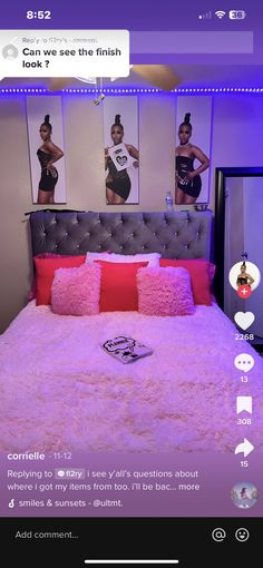 a bed with pink pillows and pictures on the wall