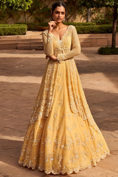 Featuring a lemon yellow lehenga in net base with sequins, beads, and pearl embroidery. It is paired with a matching dupatta and a high-low jacket.   FIT: Fitted at bust and waist. COMPOSITION: Net. CARE: Dry clean only. New Dress Design Indian, Seema Gujral, Kurta Lehenga, Indian Wedding Gowns, Indian Outfits Lehenga, Yellow Lehenga, Lehenga Blouse Designs, Gaun Fashion