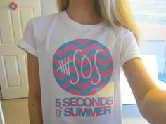 a girl wearing a t - shirt with the words 50 seconds to summer printed on it