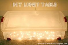 a plastic box with lights on it and the words diy light table above it