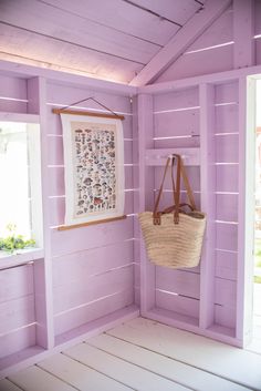 a purple painted room with a basket hanging on the wall