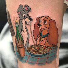 the lady and the tramp tattoo on the leg shows spaghetti with dogs in it