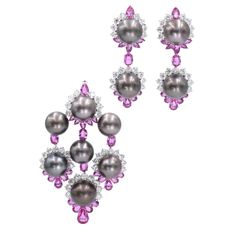 Pink Sapphire, Diamond, and Cultured Grey Pearl Pendant and Earrings. This pendant has 35 round brilliant diamonds with a total carat weight of approximately 8.75ct and 25 pink sapphires, oval and pear shape, with a total carat weight of approximately 10ct, all set in platinum. Stamped PT950, 156.61, 11.68, 3.73, 8.98. Measurements: 3.25 inches x 2 inches x 0.875 inches The earrings has 34 round brilliant cut diamonds with a total carat weight of approximately 8.5ct and and 24 pink sapphires, oval and pear shape, with a total carat weight of approximately 8ct, all set in platinum. Stamped PT950, 91.64, 1.90, 8.85, 8.03. Measurements: 2.25 inches x 0.75 inches x 0.875 inches For the set, the total diamond weight is approximately 17.25ct and the total pink sapphire weight is approxiamte 18ct Vintage Pearl Brooch, Fine Pearl Jewelry, Pearl Pendant Earrings, Pink Sapphire Pendant, Pearl Jewels, Diamond Bows, Blue Sapphire Diamond, Diamond Brooch, Fine Jewels