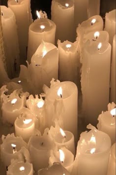 many white candles are lined up together