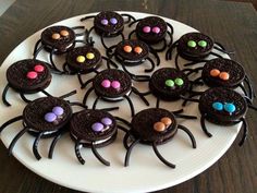 there are chocolate spider cookies on the plate