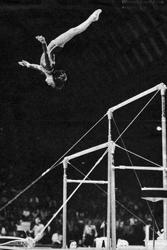 a man flying through the air while riding a skateboard in front of an audience