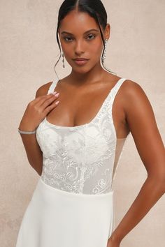 Everything will feel instantly perfect the moment you step into the Lulus Positively Romantic White Sheer Mesh Embroidered Maxi Dress on your big day! Intricate embroidery and shiny clear sequins adorn sheer mesh fabric as it shapes a seamed bodice with padded, lined cups, a scoop neckline, a low-cut back, and slender tank straps. The high, fitted waist tops a crepe knit A-line skirt that cascades down to a sweeping maxi hem with a lovely train at the back. Hidden back zipper/clasp. Fit: This ga Fitted Bridesmaid Gown With Sheer Bodice, Fitted Sequin Wedding Gown, Wedding Dress With Sheer Bodice And Heart-shaped Neckline, Fitted Bridesmaid Gown With Illusion Neckline, Lace Wedding Dress With Heart-shaped Neckline, Fitted Lace Gown With Illusion Neckline, Fitted Lace Gown With Sheer Back, Fitted Wedding Gown With Straight Neckline, Embroidered Sweetheart Neckline Wedding Dress