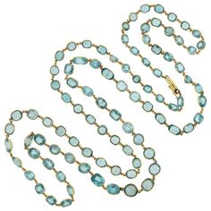 An absolutely exquisite blue zircon necklace from the Art Deco (ca1920s) era! Crafted in 14kt yellow gold, this stunning piece adorns 92 natural blue zircon stones, each separated by a delicate chain link. The sparkling stones graduate slightly in size and vary in shapes, all together weighing approximately 115.00ctw combined. The vibrant blue zircons are bezel set within a smooth eyeglass setting, allowing the light to beautifully catch the facets with every turn. Thanks to the length of the pi Festoon Necklace, Jeweled Shoes, Zircon Necklace, Diamond Necklace Set, Art Deco Necklace, Gold Art Deco, Yellow Gold Setting, Cz Jewelry, Delicate Chain