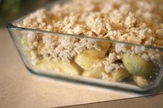 a casserole dish filled with crumbled toppings on top of a table