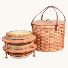 three pies stacked on top of each other in front of a basket